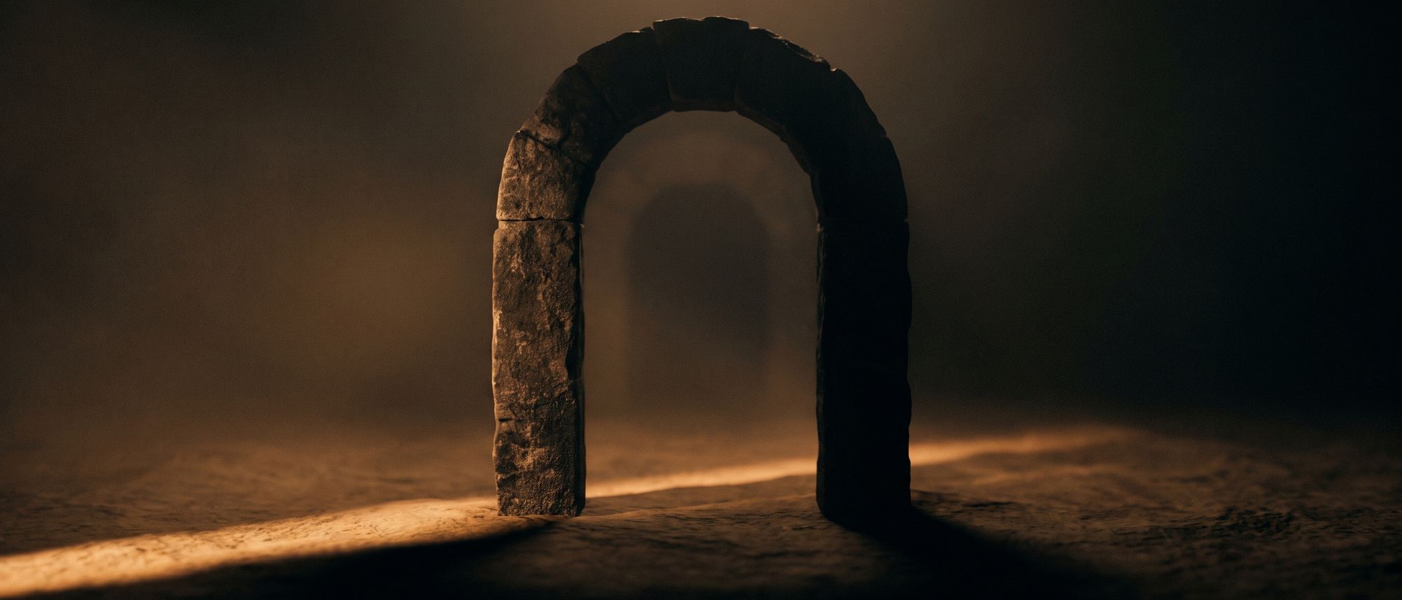 Abstract dark archway with a thin line of warm orange light running through it into darkness